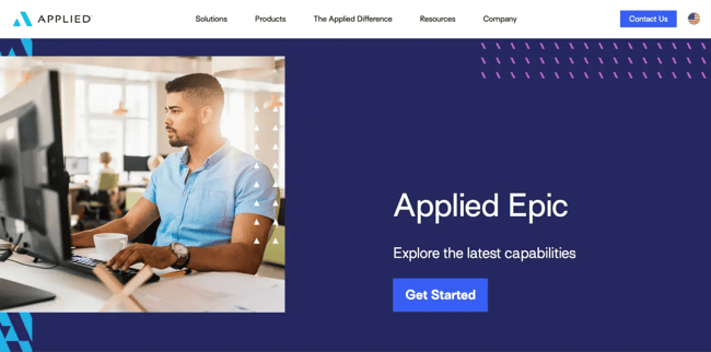 Insurance agent working at a desktop in office environment for Applied Epic